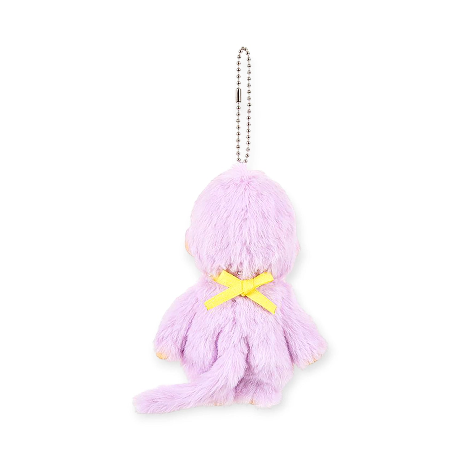 The Monchhichi Colours Bag Charm - Purple by Monchhichi is a small, plush animal keychain with a yellow bow on its back—a charming accessory or gift.
