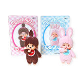 The Monchhichi plush toys—a brown monkey and pink bunny—boast a soft-touch finish and charming design. Their boxes feature coordinating pink and blue illustrations, echoing the allure of a Monchhichi Flocked Figure from the Original Series Blind Box by Monchhichi.
