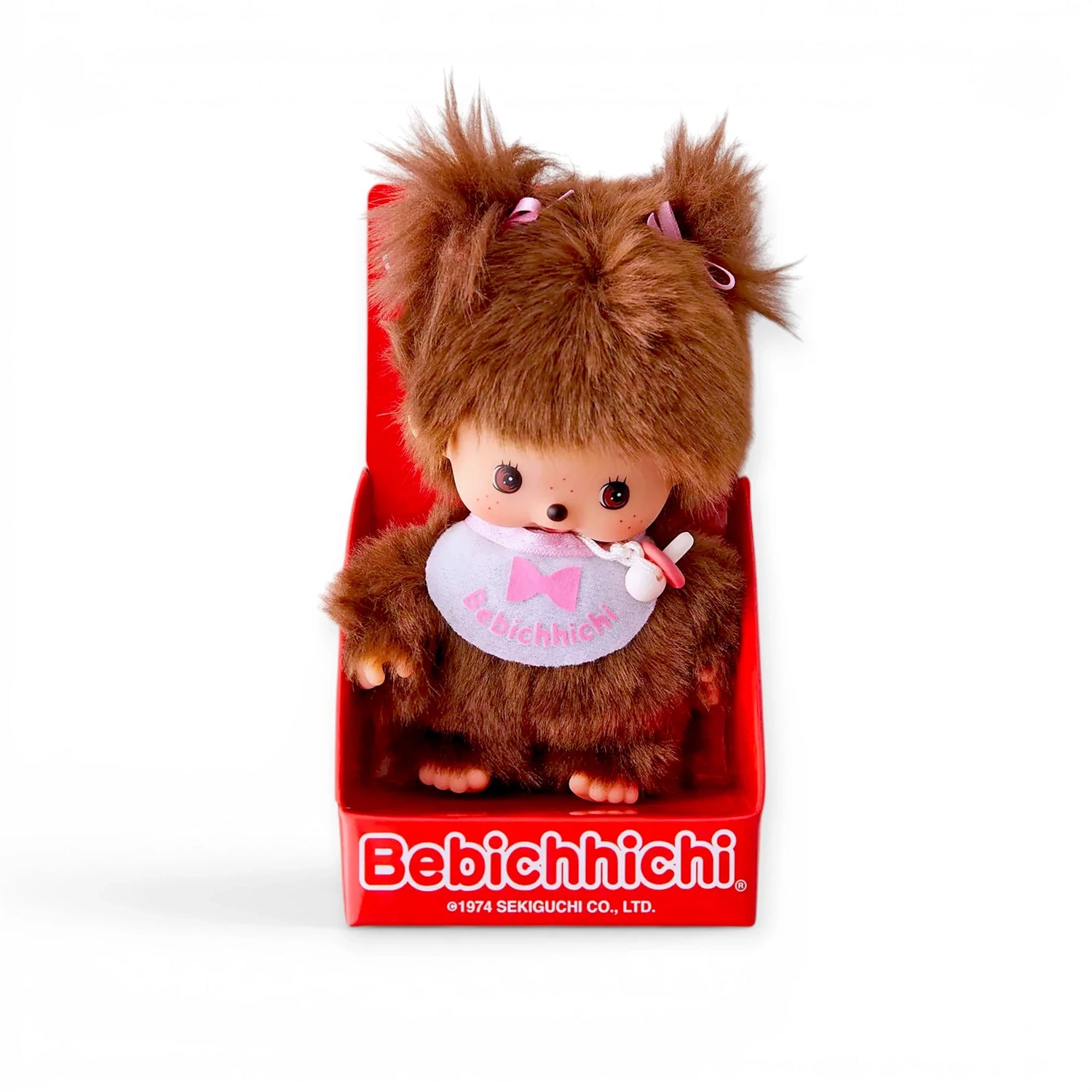 Brown plush doll with soft hat and white bib with pink bow
