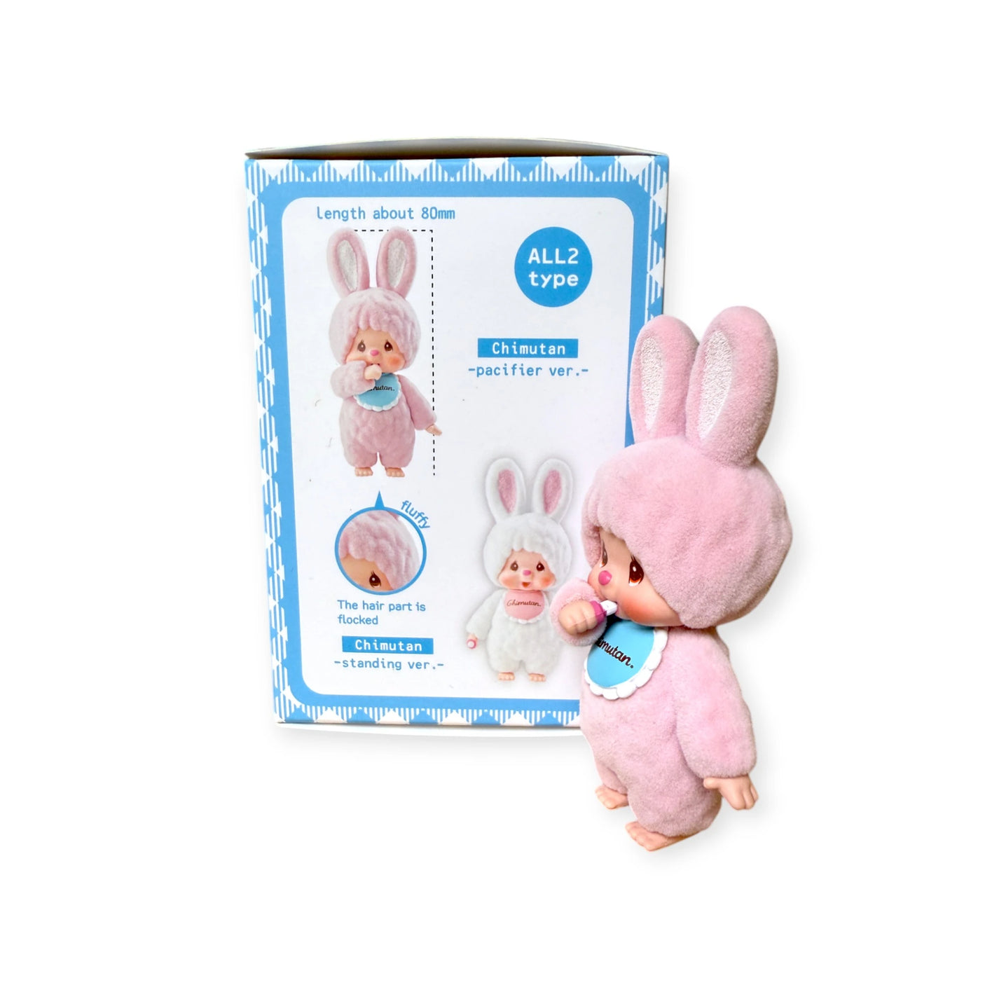 A charming Monchhichi Flocked Figure from the Chimutan Series, featuring a pink bunny costume with long ears, stands next to its box showcasing product images and details. It's perfect for collectors and fans of whimsical characters.