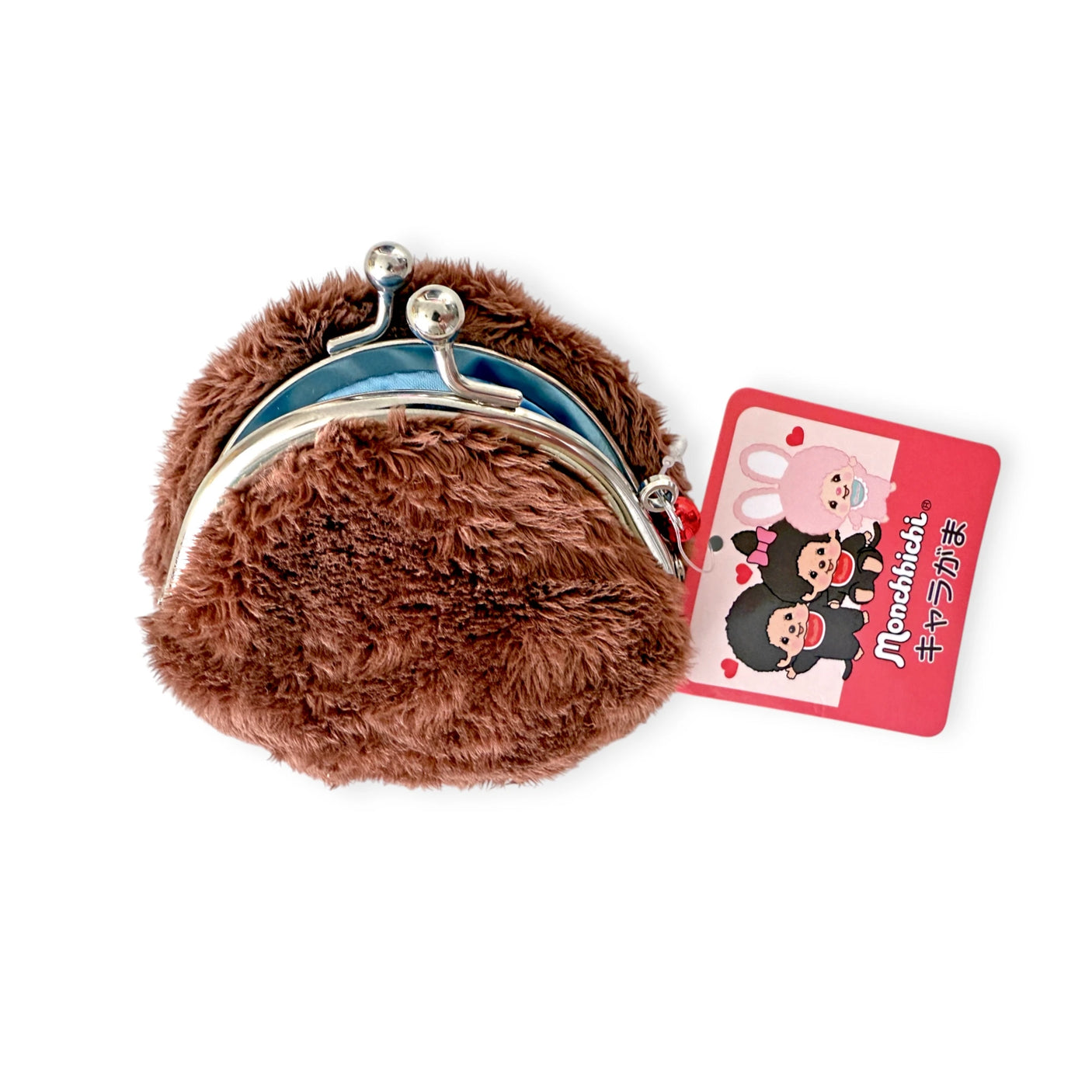 The Monchhichi Coin Pouch - Boy is a small, brown, furry delight with soft faux-fur and a secure clasp. It opens up to reveal a light blue interior and features a red tag adorned with cartoon characters and Japanese text, adding extra charm.