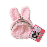 A fluffy, pink plush rabbit-shaped coin purse with a metal clasp and a cartoon character tag resembles the Monchhichi Coin Pouch's delightful Chimutan design.