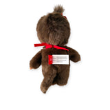 A charming Monchhichi Plush Doll featuring a brown teddy bear with a red ribbon is seen from the back. As a vintage collectible, it has two tags, making it ideal for enthusiasts.