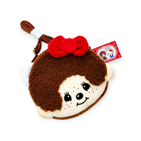 The Monchhichi x Hello Kitty Shoulder Bag by Monchhichi is a Japan exclusive plush crossbody featuring a cartoon girl’s face with brown curly hair, a red bow, and tag—ideal for collectors of unique collaborations.