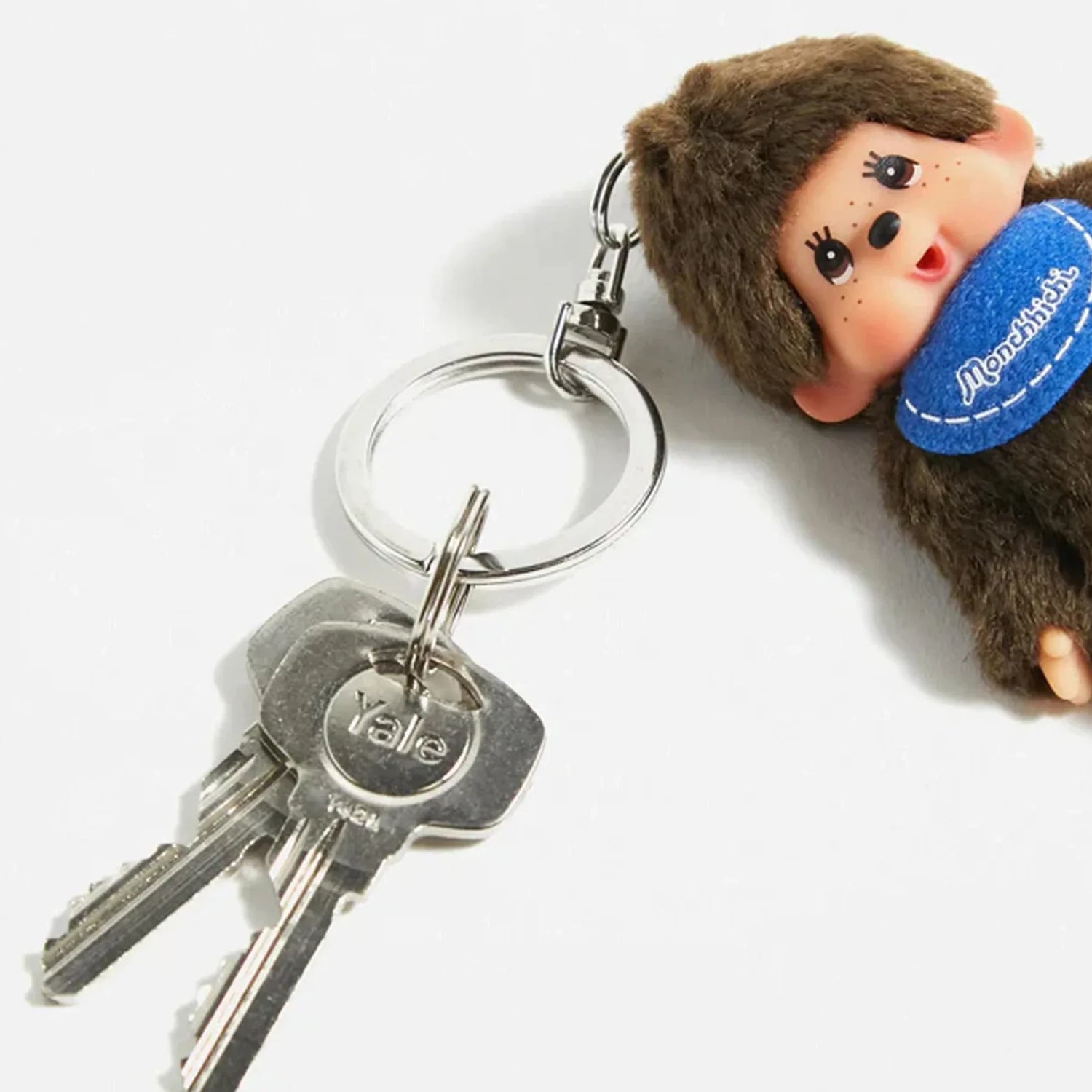 Brown plush Monchhichi keychain with silver keyring and blue scarf