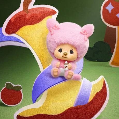 Pink pig-eared Monchhichi pendant figure in a purple outfit on a card