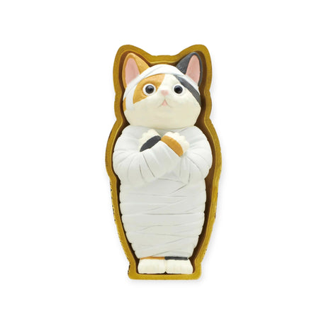 A "Mummy Cat Blind Box" by Kitan Club features a figurine of a mummy cat, wrapped like a calico cat emerging from an enchanting sarcophagus, set against a white background.