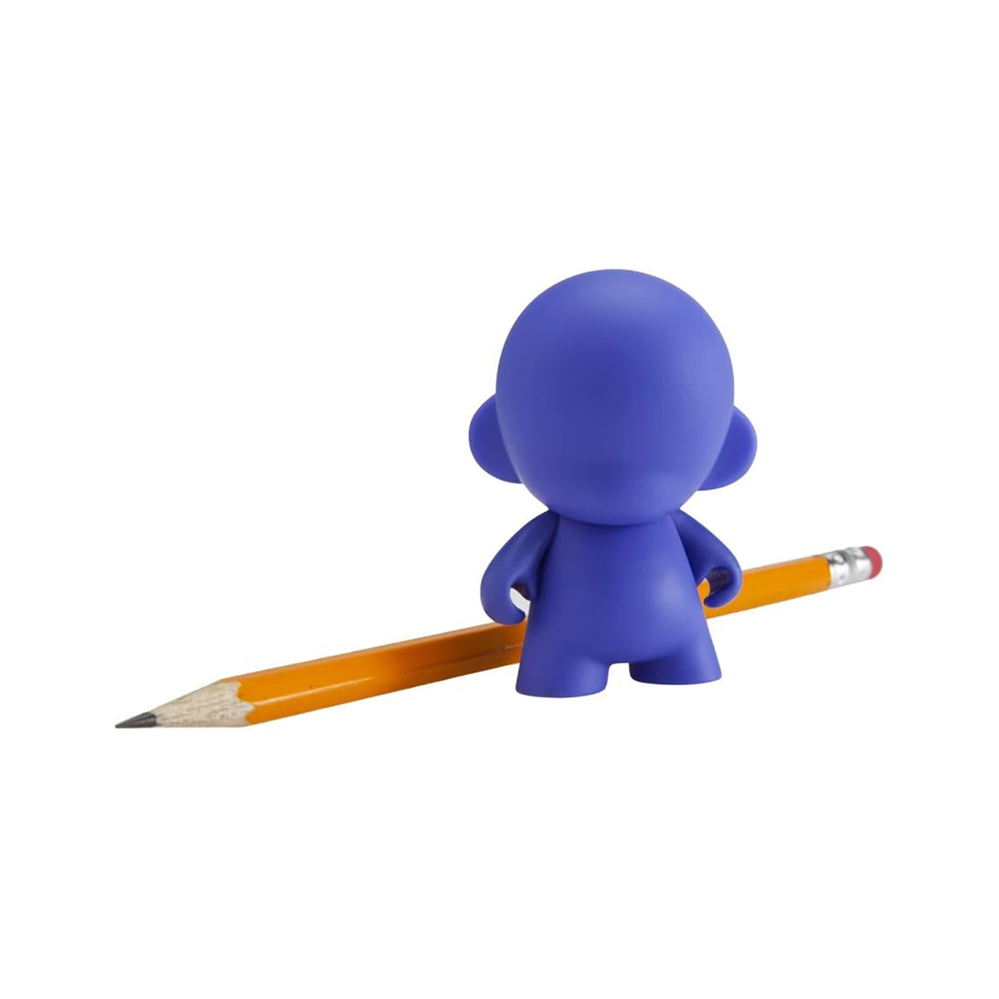 A small blue figurine facing away, reminiscent of a Kidrobot Munnyworld DIY Personalised Pop Vinyl mini figure, stands beside a yellow pencil.