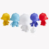 Kidrobot's Munnyworld DIY Personalised Pop Vinyl mini figures in vibrant colors like yellow, blue, white, purple, and red await your creative touch with a paintbrush and palette next to the white figure. They're perfect for crafting your own personalized vinyl creations.