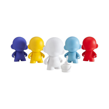 Five Munnyworld - DIY Personalized Pop Vinyl mini figures from Kidrobot, available in vibrant colors of blue, yellow, white, light blue, and red, stand beside a small white teacup. Ideal for vinyl figure enthusiasts eager to craft their own unique masterpiece.