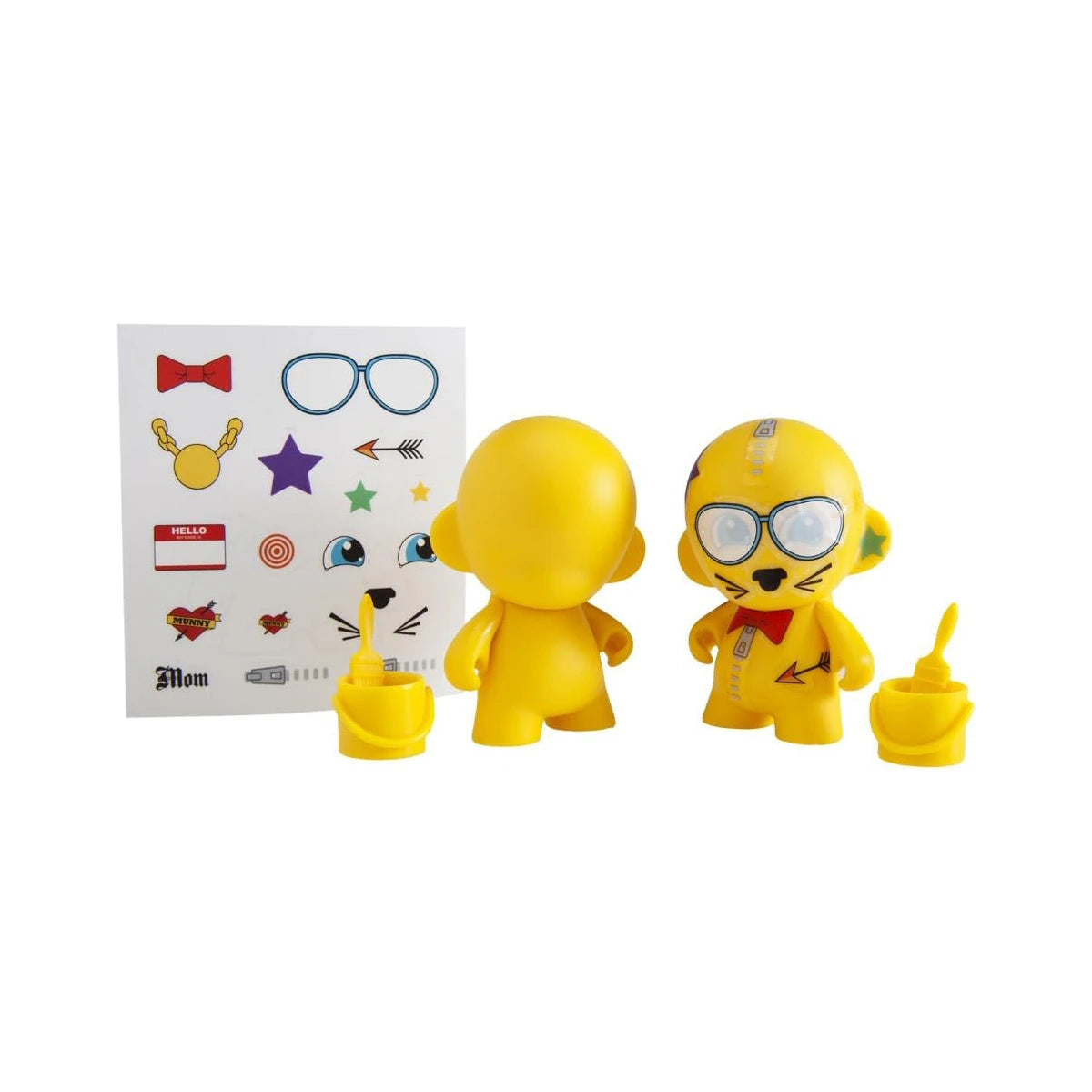 Kidrobot's Munnyworld DIY Personalised Pop Vinyl mini figures in yellow include two figures, complete with optional accessories and a sticker sheet showcasing designs such as glasses and stars, ideal for crafting your own custom vinyl creations.