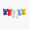 Five vibrant cat figurines in purple, red, white, blue, and yellow feature a sleek, minimalist design inspired by Kidrobot's Munnyworld – DIY Personalised Pop Vinyl mini figure. The white cat is equipped with a paintbrush and palette, encouraging creative customization just like DIY vinyl figures for a personalized touch.