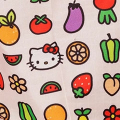 Fabric with colorful illustrations of fruits, vegetables, flowers, and a cartoon cat with a red bow.