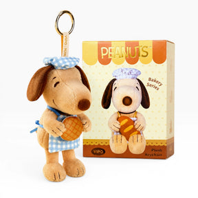 Brown plush dog keychain in blue checkered shirt, with Peanuts box