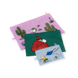 The Peanuts x Baggu Go Pouch Set by Baggu includes three vibrant bags that capture the true Peanuts style: a pink bag showcasing Snoopy and Woodstock in a desert scene, a green bag with Snoopy dressed in a red coat, and a blue bag depicting Charlie Brown flying his kite.