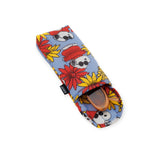 The Peanuts x Baggu Glasses Sleeve - Floral Snoopy by Baggu showcases a vibrant design featuring colorful floral and bear patterns on a blue background, with the sleeve partially open to display stylish sunglasses inside.