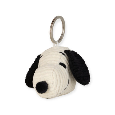 The Snoopy Head Keychain 4.5cm - Corduroy Cream, designed in the shape of a cartoon dog head with black ears and a black nose, is perfect for fans of Peanuts adventures.