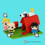 Using micro-sized blocks, the Nanoblock Peanuts - Snoopy House Set by Nanoblock features pixel-style characters and a red doghouse with a small dog figure on top, all placed on a green base.