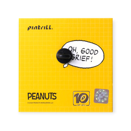 Rear view of a Snoopy Classic enamel pin backing card with a yellow grid design and black pin clasp visible