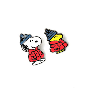 Enamel puffer-style character pins of Snoopy and Woodstock, red jackets and blue hats