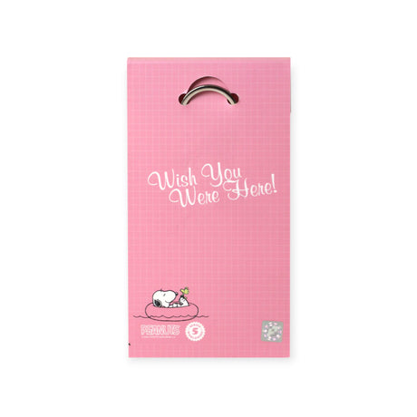 Pink Snoopy keychain packaging with Snoopy lying on a float and "Wish You Were Here!" text in white script