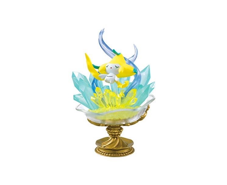 The Re-Ment Pokemon Gemstone Collection 2 features an enchanting decorative figure of a yellow and white Pokémon character, beautifully surrounded by translucent blue and yellow crystals and elegantly placed on a golden pedestal. This piece perfectly captures the essence of the Pokémon Gemstone collections.