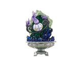 The Re-Ment Pokemon Gemstone Collection 2 features a decorative Blind Box Figure of a ghostly chandelier with purple flames, encircled by blue and green crystal-like structures, all elegantly set in a silver bowl.