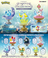 A poster featuring six Pokémon figures from the Re-Ment Pokemon Gemstone Collection 2, including Articuno, Chandelure, Jirachi, Giratina, Pichu, and Glaceon on gemstone-themed stands with sparkling effects and a decorative frame.