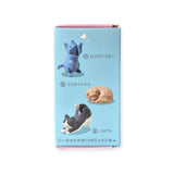 The Geometric Cats Blind Box by Yell showcases a trio of origami-style cats with Japanese labels: a standing blue cat, a lying brown cat, and a stretching black-and-white cat. This blind box is an ideal treat for cat lovers, providing the excitement of discovering an artistic feline surprise inside.