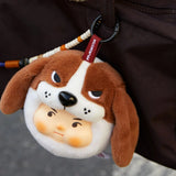 Plush dog keychain with brown-and-white face, black nose, on a strap with beads