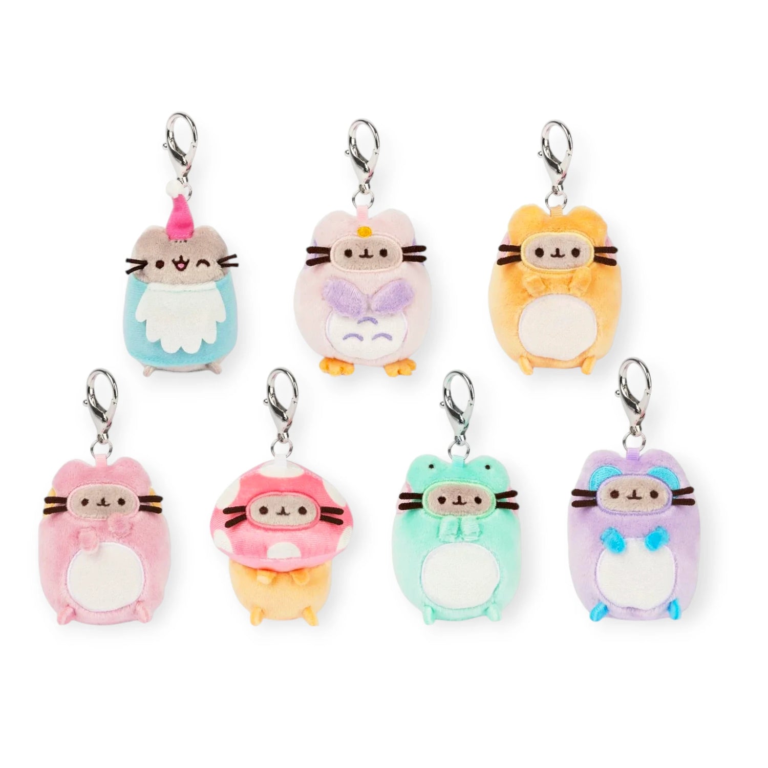 Seven colorful Pusheen Blind Box - Enchanted Forest plush keychains by Pusheen, each in unique costumes and animal shapes, are arranged on a white background—ideal for surprise unboxing.
