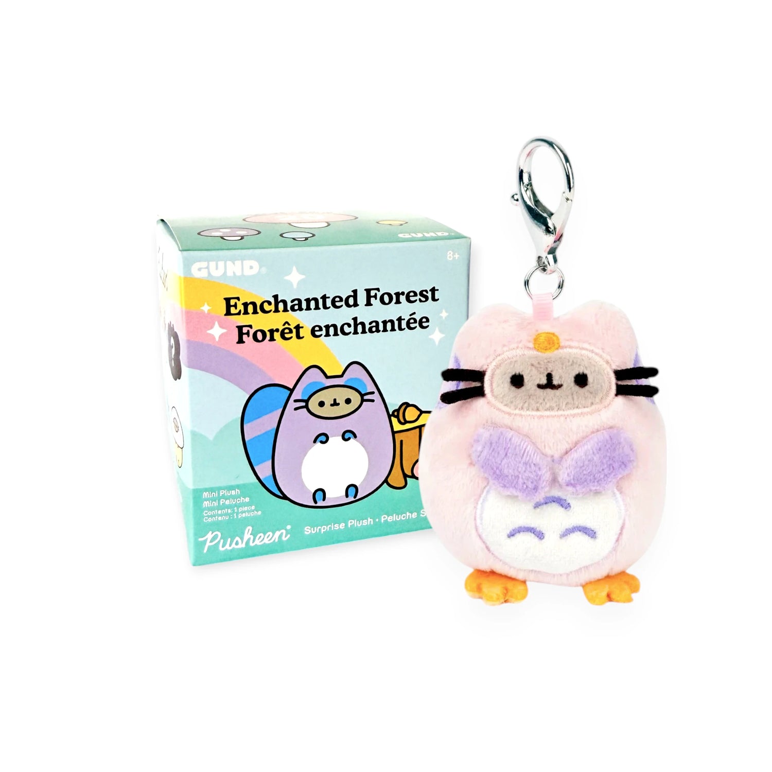 A small Pusheen plush keychain dressed as a purple owl, from the Pusheen Blind Box – Enchanted Forest series, shown next to its original packaging.