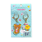 The Japan-exclusive Rilakkuma Harajuku 2 Piece Keychain - Limited Edition features a bear and a chick on a mint green backing card, along with extra small googly eyes. Perfect for collectors of unique Rilakkuma treasures.