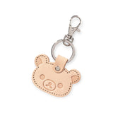 Discover Japanese elegance with the Rilakkuma Korilakkuma Leather Keychain. This stylish and functional accessory features a bear's head design in premium leather with embossed facial details and a durable metal clasp.