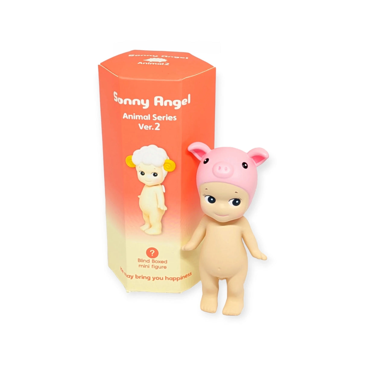 A small doll with a pink pig hat stands next to a hexagonal orange Blind Box displaying "Sonny Angel Animal Version 2 Series" by the brand Sonny Angel.