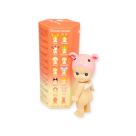 A Sonny Angel figure from the Animal Version 2 Series, featuring a pig-shaped hat, is displayed alongside a Blind Box that includes cartoon characters such as a fawn, reindeer, cow, and more.