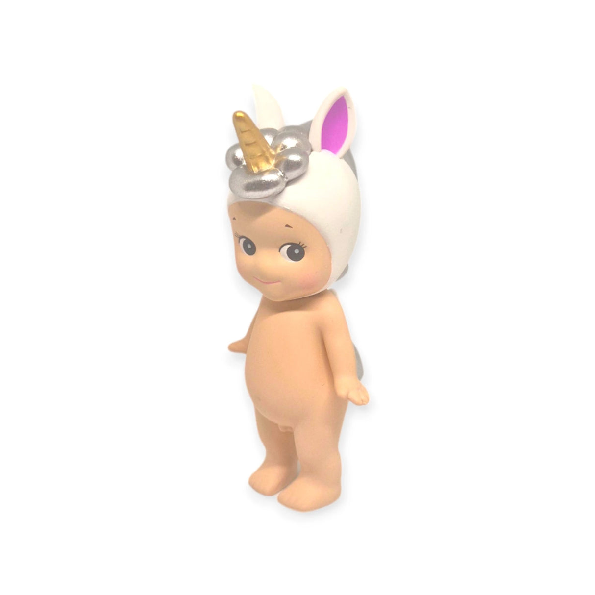 A small, nude figure from the Sonny Angel Animal Version 3 Series by Sonny Angel wears a white unicorn hat featuring a golden horn and pink ears, all against a plain white background. Celebrated for their charm, these collectible dolls are typically found in mystery-filled blind boxes.