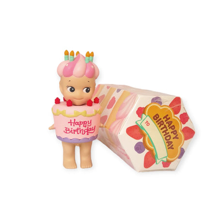 The Sonny Angel Happy Birthday Cake Gift by Sonny Angel features a charming toy figure dressed in a birthday cake costume adorned with candles, housed in a festive "Happy Birthday" box. As part of the delightful Birthday Cake Series, it offers an exciting surprise experience similar to uncovering hidden treasures in a Blind Box.