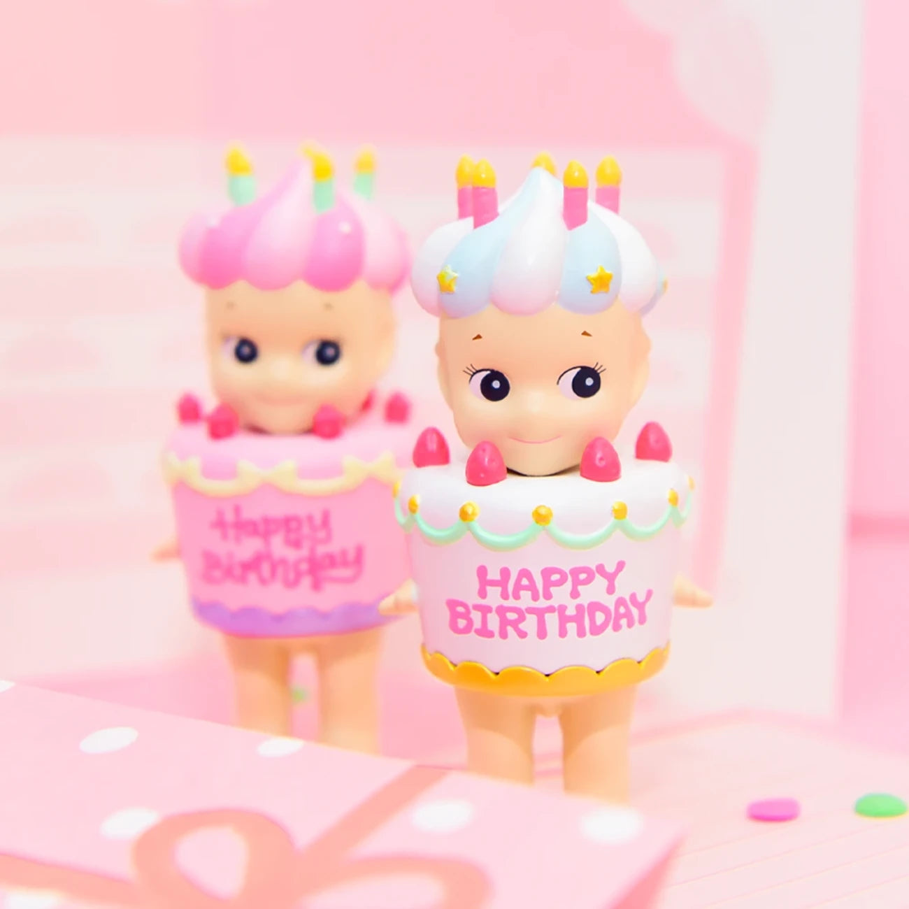 The Sonny Angel Happy Birthday Cake Gift toy figures are delightful additions to the Birthday Cake Series, featuring "Happy Birthday" on a charming pink background.