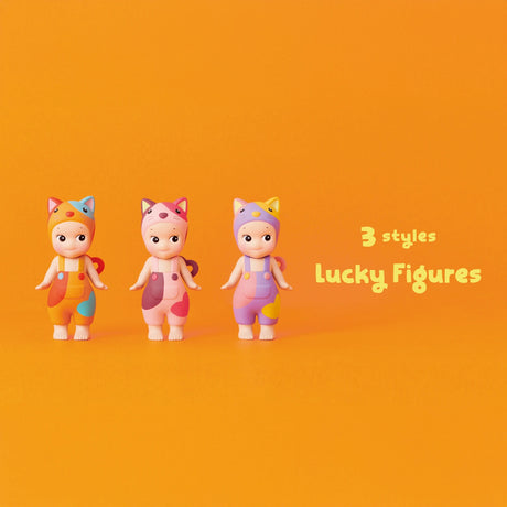 Three toy figures from the Sonny Angel Cat Life Series stand against an orange backdrop with the text "3 styles Lucky Figures." Dressed in vibrant animal-themed outfits, these limited edition figures by Sonny Angel add a playful touch to any collection.