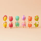 Six Sonny Angel figurines from the limited edition Dinosaur Series stand in a row on a beige background, their backs to us. Featuring colorful, animal-themed costumes, these prehistoric pals by Sonny Angel capture imaginations with delightful charm and vintage flair.