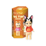 A small figurine wearing a dog-themed hat and costume, holding a tiny bone. The packaging highlights the "Sonny Angel Dog Time Series" by Sonny Angel, featuring an image of the collectible mystery figure—ideal for enthusiasts.