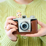 Cherry blossom Hippers mini figure on a brown camera held by hands