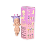 The Sonny Angel Hippers Blind Box - Dreaming from Sonny Angel features a toy figure with purple antennae next to a pink box showcasing 12 different character options, including the Secret Unicorn from the Dreamy Animal Collection.