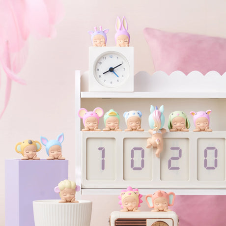 Charming figurines from the Sonny Angel Hippers Blind Box - Dreaming collection by Sonny Angel are dressed as various animals and displayed on a white shelf next to a digital clock reading "10:20," all surrounded by gentle pastel decor.