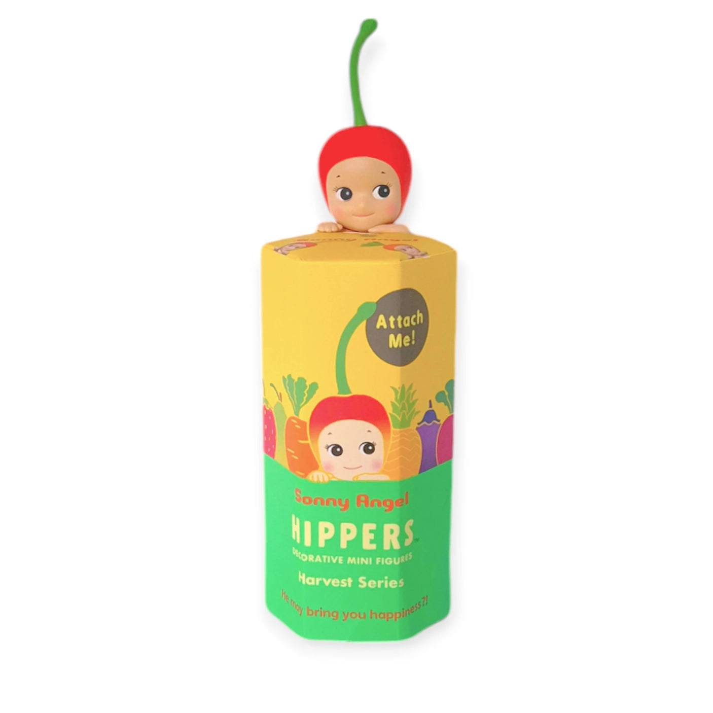 A small, cherry-themed Sonny Angel figure from the "Hippers Harvest Series" is perched on the yellow and green cylindrical packaging of the Sonny Angel Hippers Blind Box - Harvest, making it an ideal addition for whimsical figure collectors.