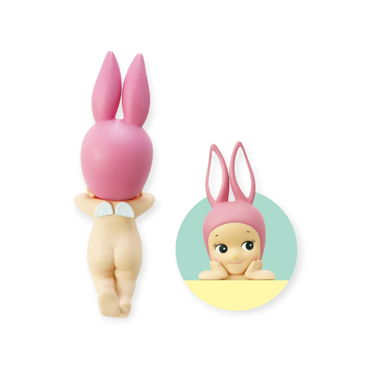 This delightful figurine, from the Sonny Angel Hippers Blind Box - Animals series by the brand Sonny Angel, showcases a nude doll adorned with angel wings and a pink bunny hat. With its face resting on its hands when viewed from behind, this versatile piece can be easily repositioned using its reusable adhesive base.