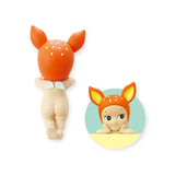 Celebrate the Animal Series with this Sonny Angel Hippers toy figure from the Sonny Angel brand, featuring an orange deer-themed hood. It offers a circular inset view that displays both front and back designs. Ideal for collectors, its reusable adhesive allows it to stick securely without leaving any residue.