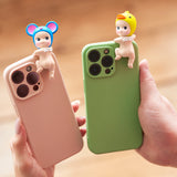 Two hands hold smartphones with vibrant cases, each decorated with a Sonny Angel Hippers figurine from the "Looking Back" blind box collection: one showcases a blue mouse hat, while the other sports a yellow duck hat. These collectible figures by Sonny Angel add whimsical charm to any device.