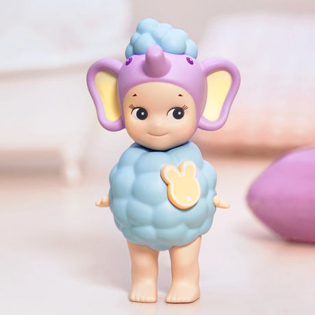 This adorable figure from the Sonny Angel Home Sweet Home Series showcases a character dressed in a gentle, pastel-hued elephant costume, complete with a blue, bubble-shaped body and expansive ears. Ideal for any collection under the Sonny Angel brand, it adds a touch of charm and coziness to your decor.